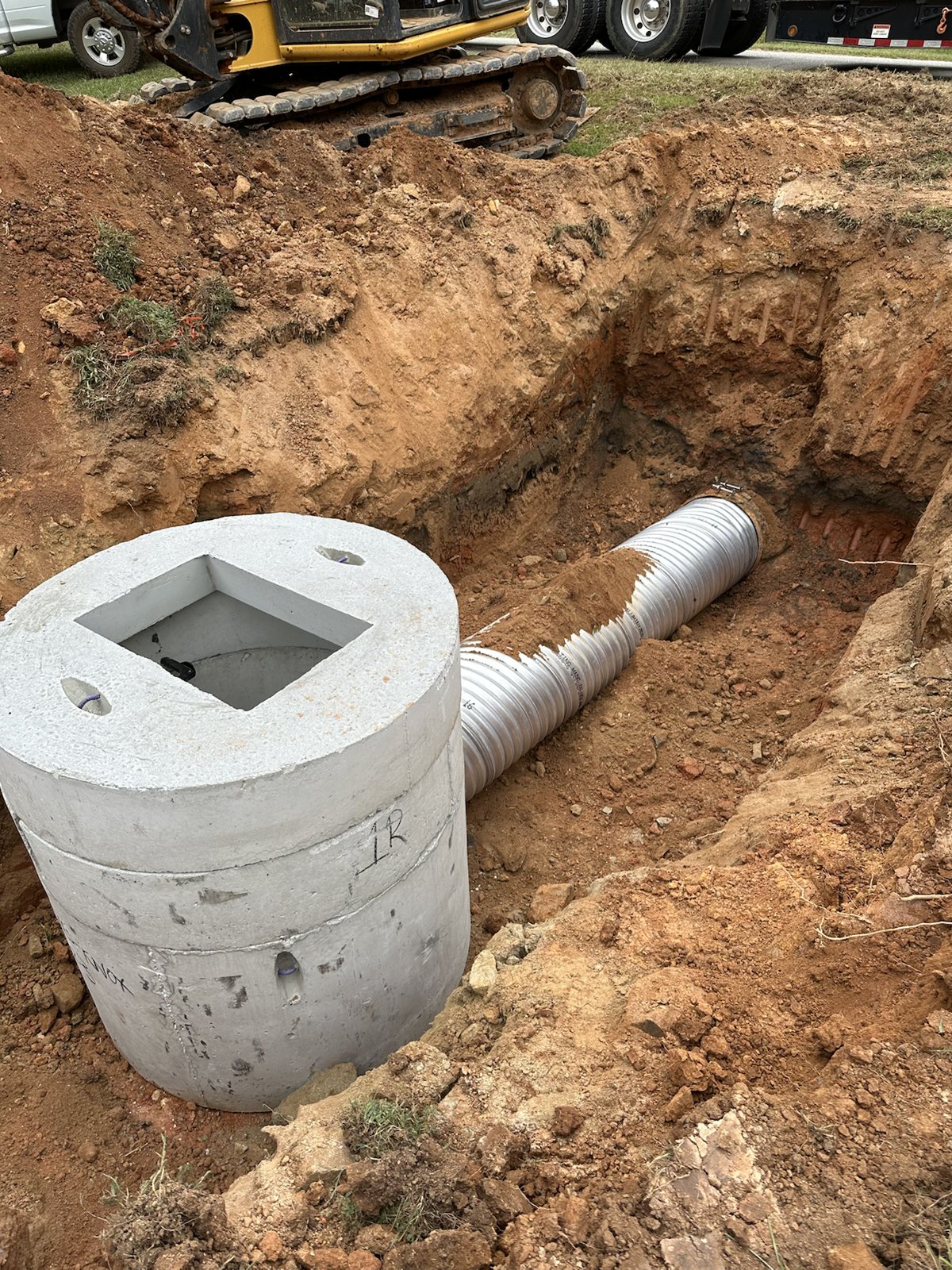 Concrete storm drain structure and pipe after installation